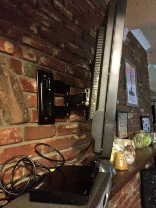tv mounted to brick