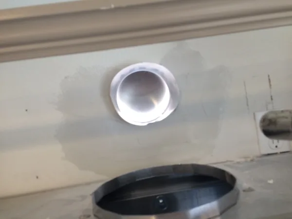 inside wall. cut hole for venting and patched it